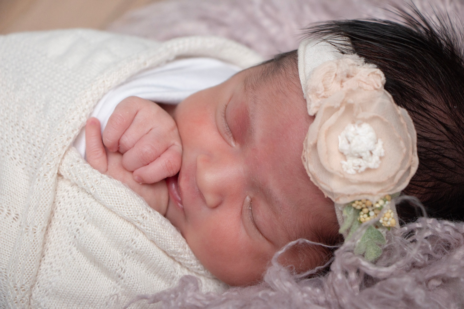 Newborn baby wearing a delicate floral headband